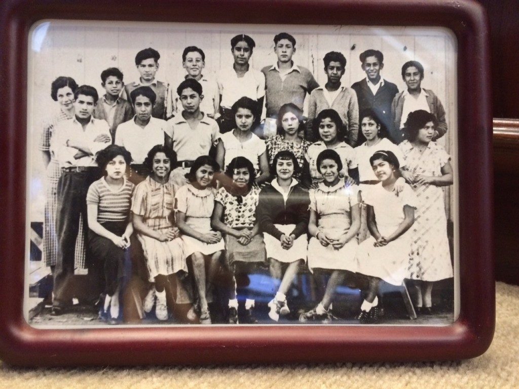 School photo in black and white of three rows of Mexican American students posing for the camera.
