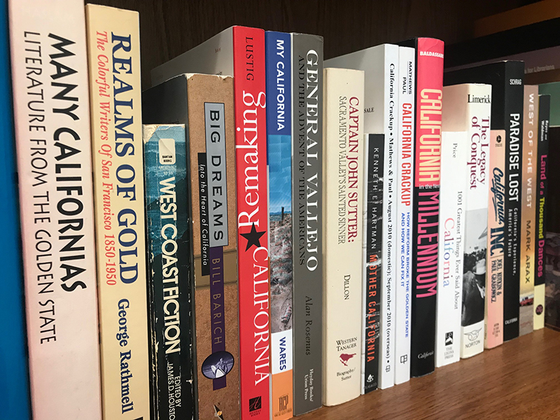 A shelf of books with titles about California.
