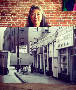 A woman holds up a black-and-white photo with an image of an old downtown area on it.