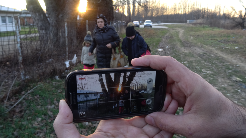 A cell phone camera captures a family.