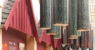 A picture of a model that shows a log cabin and hanging trees.