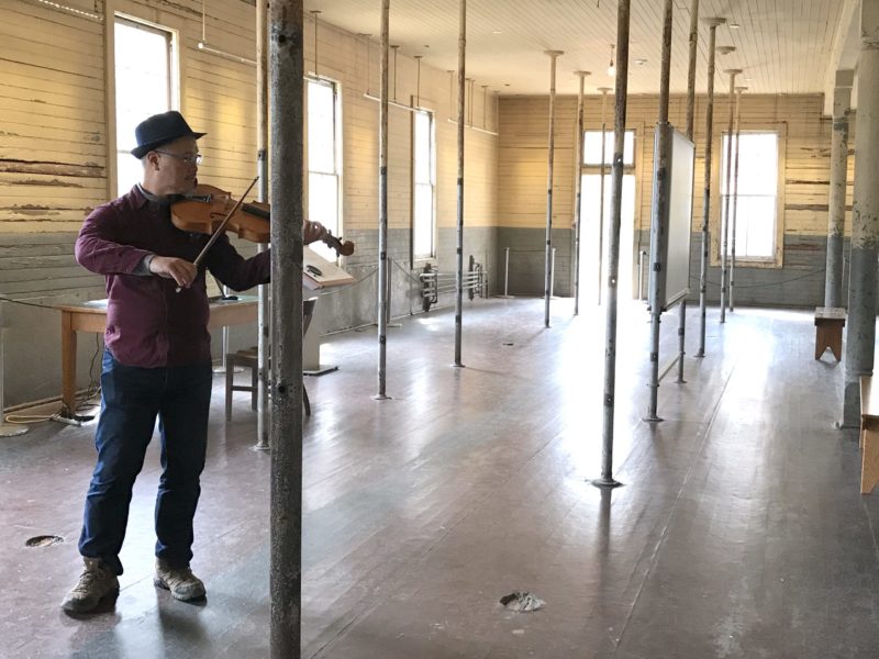 Charlton Lee of The Del Sol String Quartet plays his viola in the Immigration Station barracks on Angel Island.