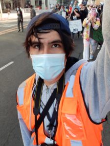 A selfie of Erik Galicia. A mask is covering the lower half of his face.