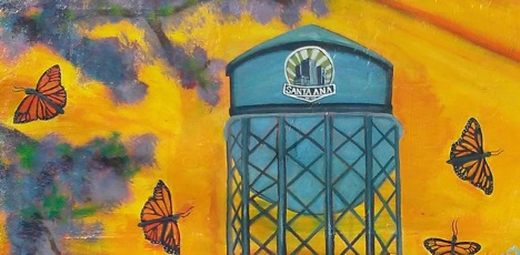 A colorful portrait with butterflies and a water tower that reads, “Santa Ana”.