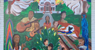 A bright and colorful mural depicting multiple persons engaged in activities such as playing the guitar and sitting in a garden.
