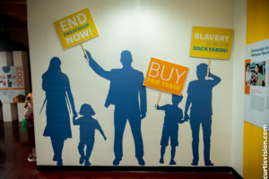 Silhouettes of people holding picket signs.