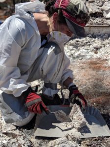A professional from the cremains recovery team sifts through the ashes.