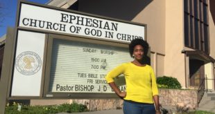 Krystal stands in front of the Oakland Ephesian Church sign.