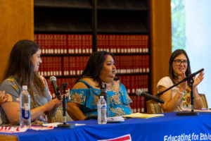 Lily Gonzalez, Priscilla Terriquez, and Irene Sotelo sit at a table speaking.