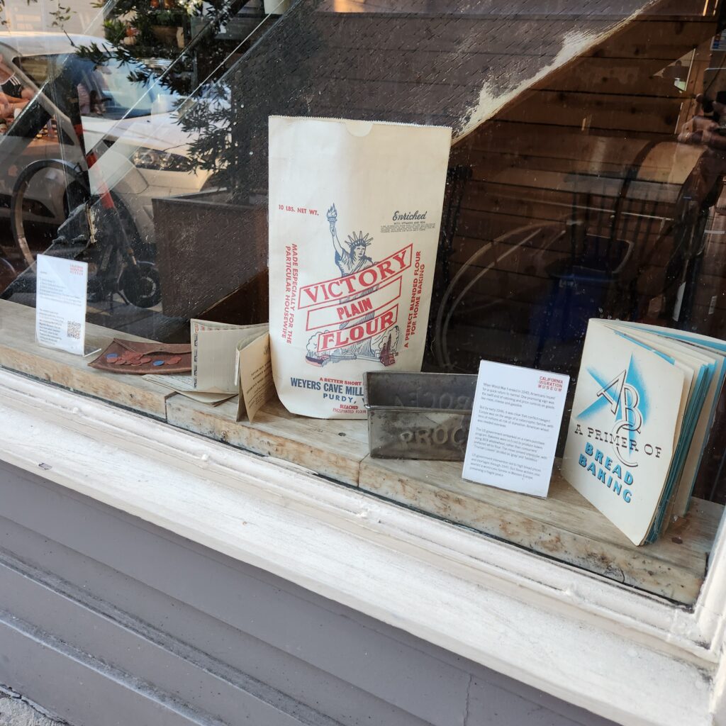 Objects and ephemera displayed in the window of a restaurant 
