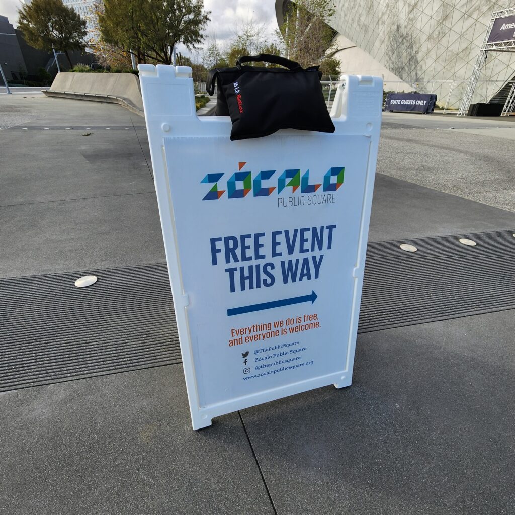 Sandwich board with Zocalo log and text "Free event this way"