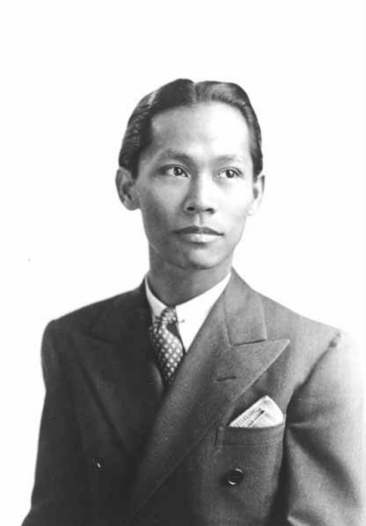 Black and white portrait of a man wearing a suit and tie