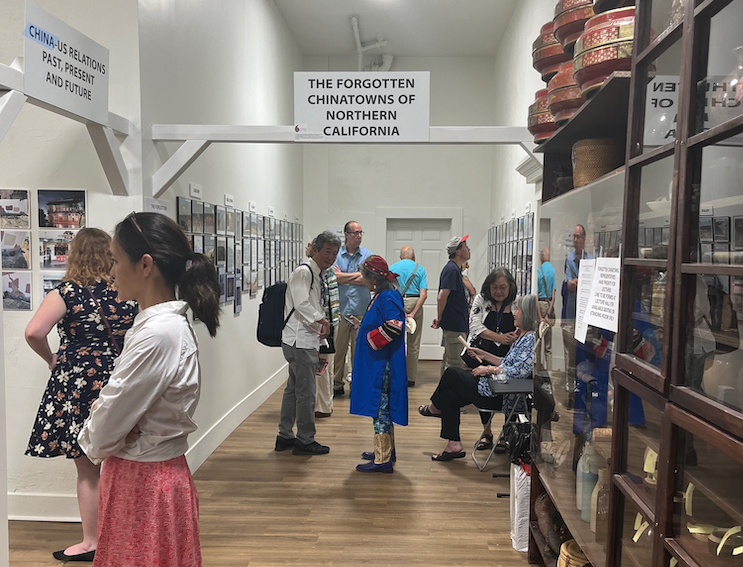 People inside an exhibit gallery reading panel information